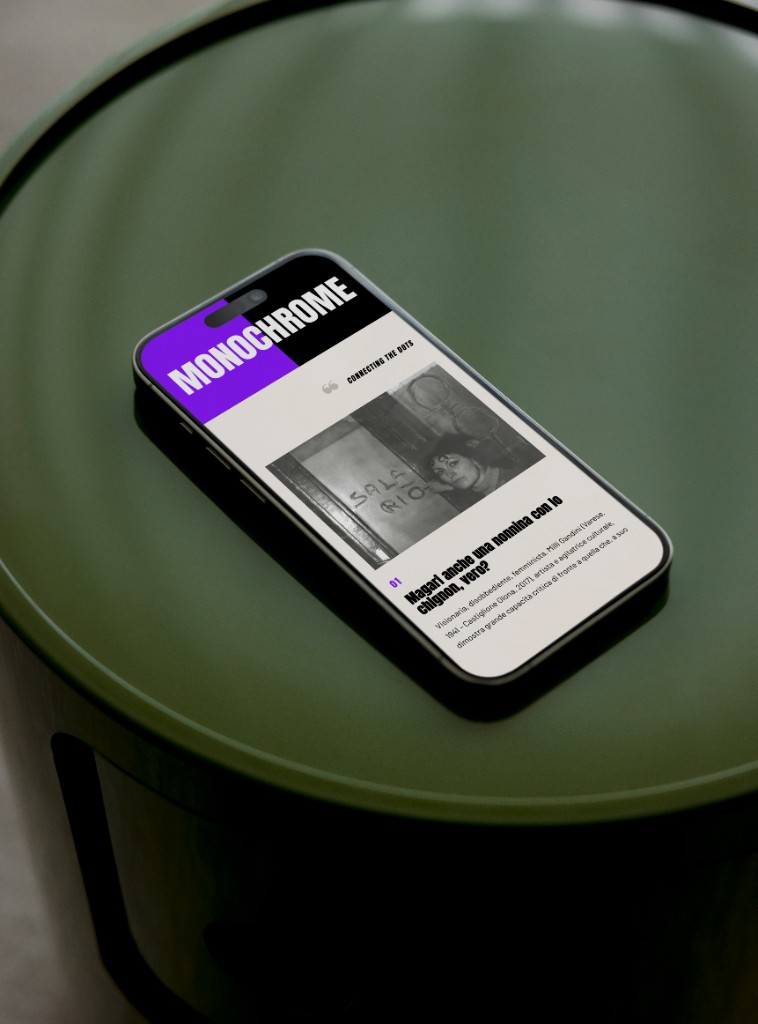 Telefono su un tavolo verde, con l'articolo su Milli Gandini aperto.